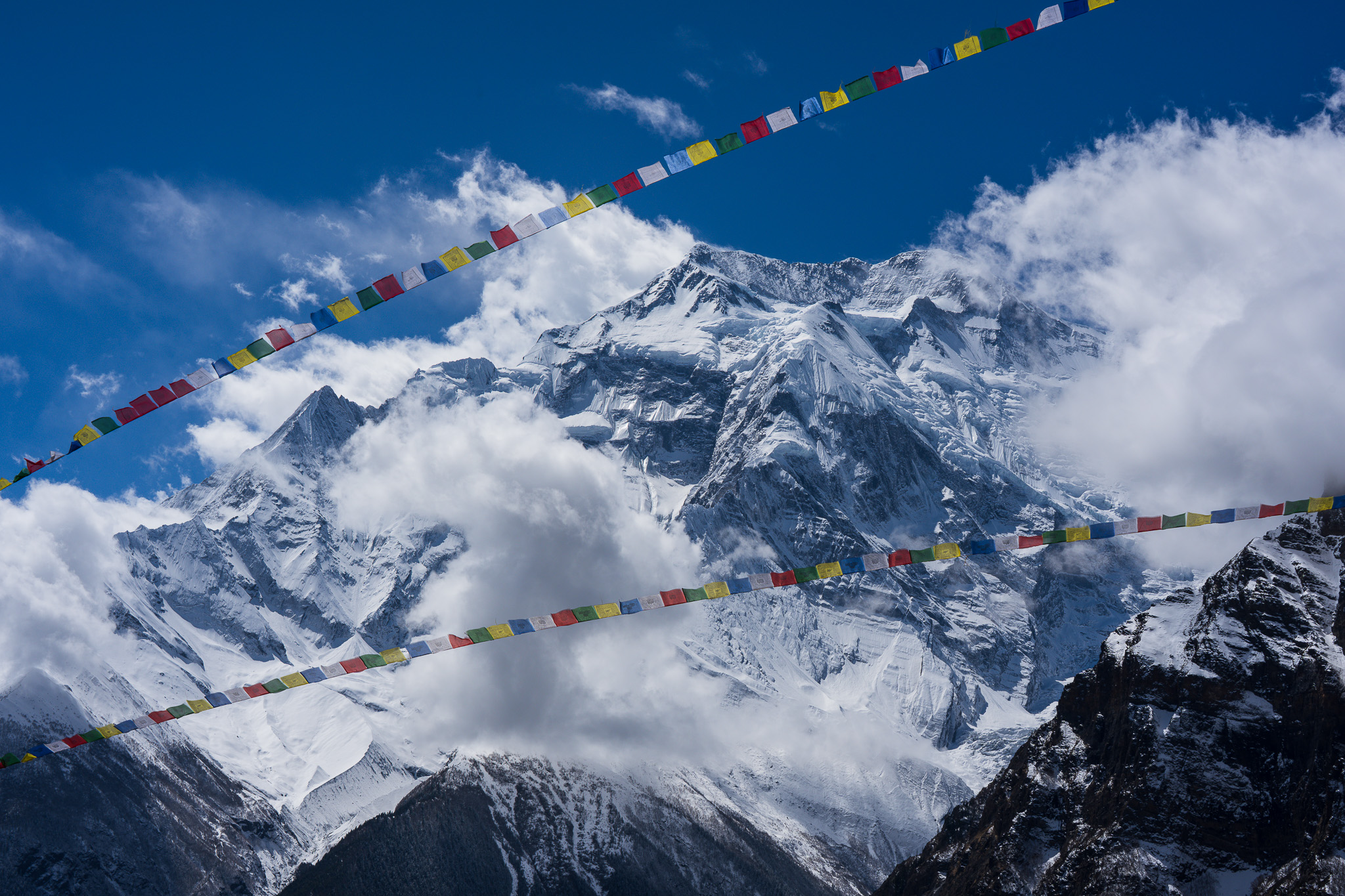 Scenic view of a mountain with colorful buddhist flags hanging around